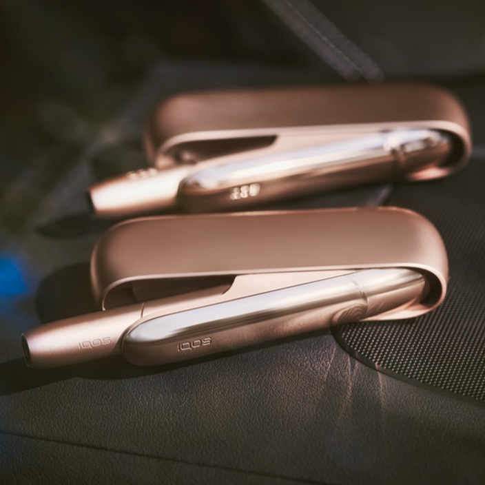 Two Brilliant Gold IQOS 3 DUO holders in open pocket chargers