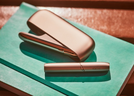 Brilliant Gold IQOS 3 DUO on green notebook